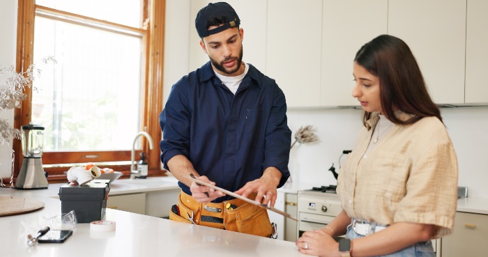 Homeowner consulting plumber about services before hiring in Naperville, IL